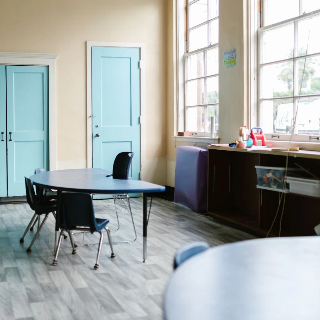 Empty KISD elementary classroom with chairs stacked on desks during a teacher planning day.